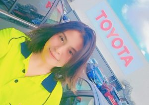 Roma Gawhari wearing hi-vis shirt standing outside of Toyota